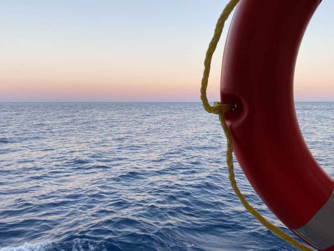 a lifebuoy on the background of the blue sea