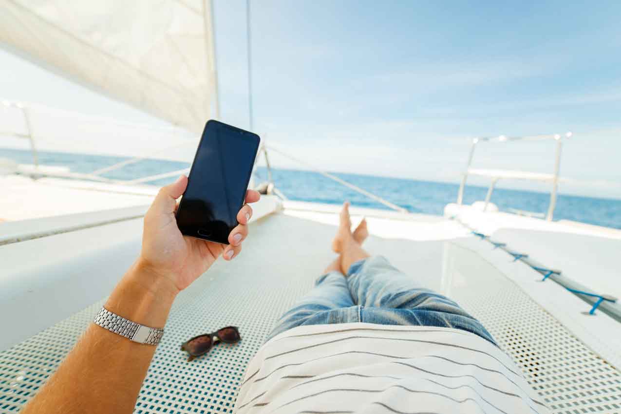 person resting on yacht while sailing during the summe