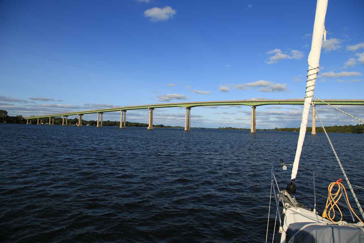 sailboat approaching bridge in the bay of quinte