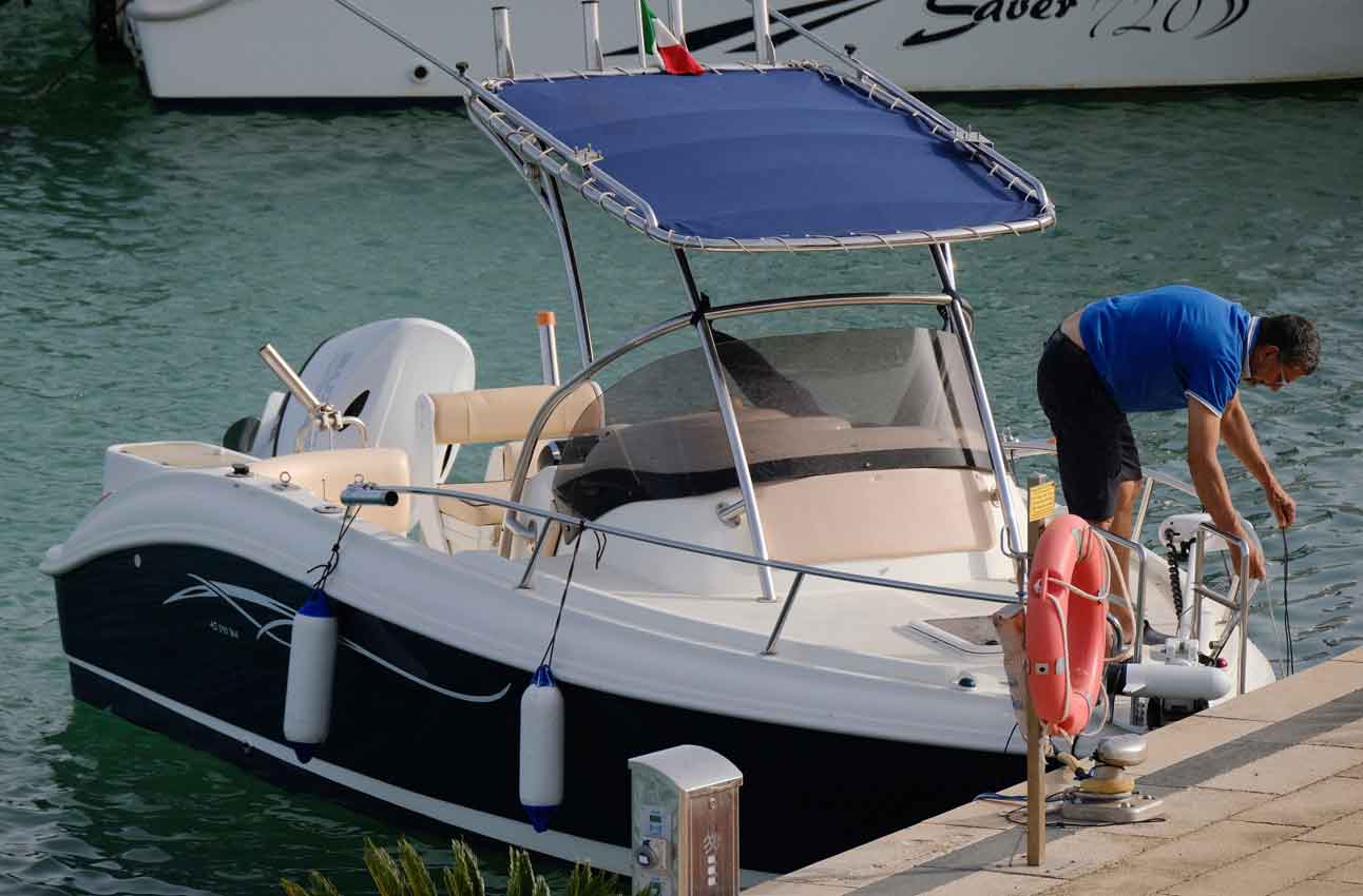 sport fisherman on a motor boat near a marina