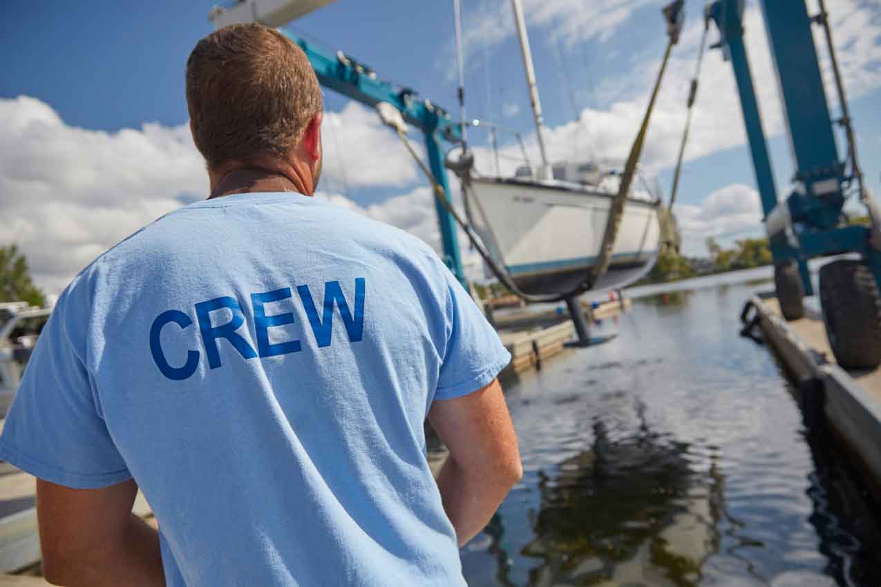 close up of a crew member overlooking a boat hauling at crate marine belleville