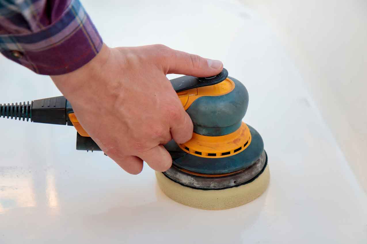 Man sanding yacht, hand close up