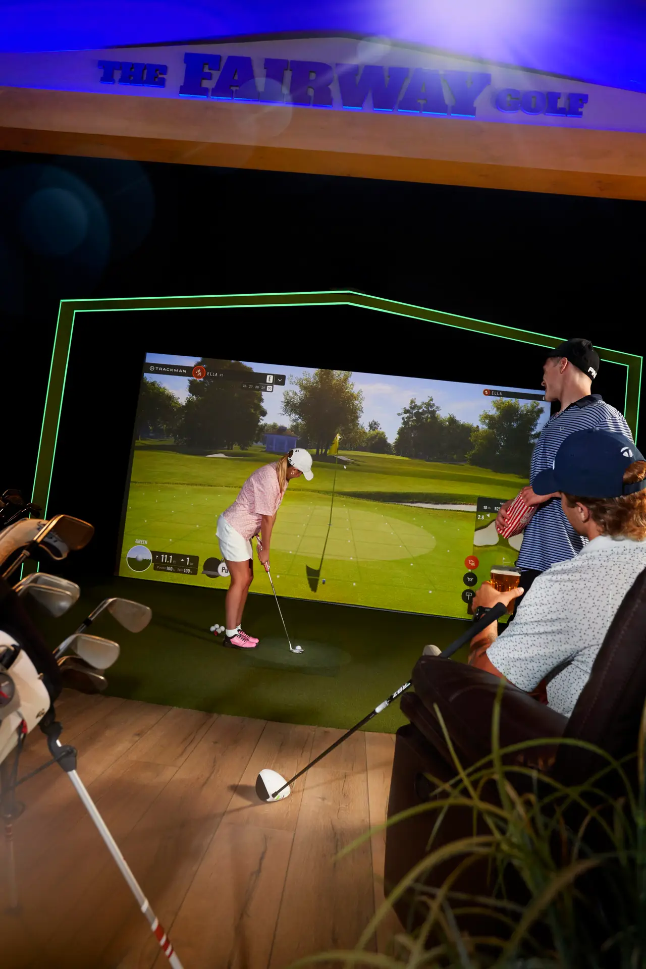 Golfer putting on the 4K TrackMan golf simulator at The Fairway Belleville